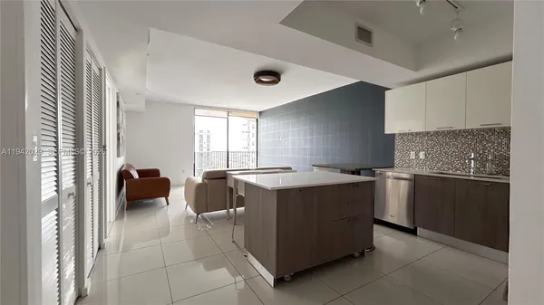 a kitchen with a stove and a refrigerator
