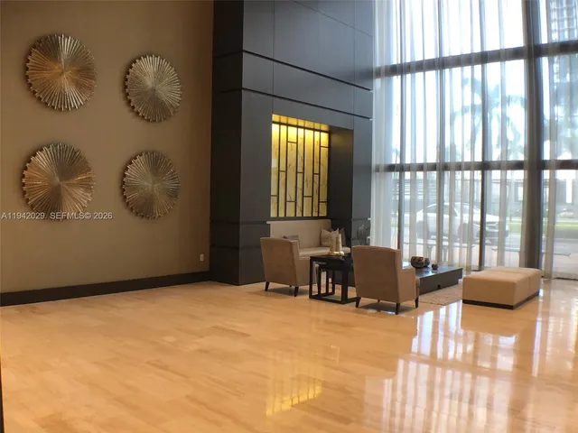 a bedroom with furniture and large windows