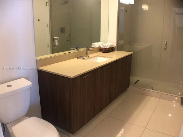 a bathroom with a sink a toilet a mirror and vanity