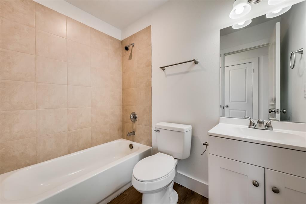 126 Lynn Court, Unit 100 Decatur, TX 76234 - Photo 15 of 20 a bathroom with a sink a toilet and shower
