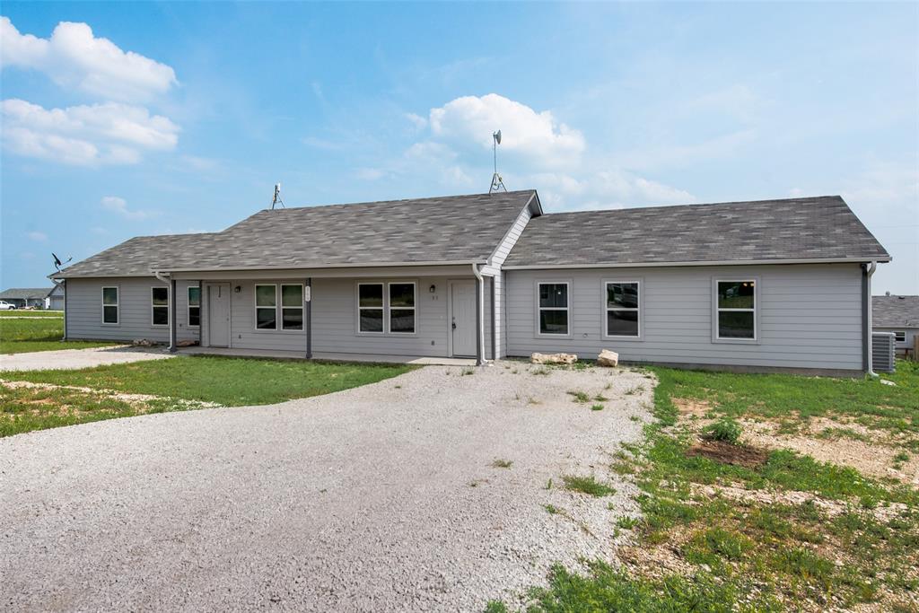 126 Lynn Court, Unit 100 Decatur, TX 76234 - Photo 4 of 20 a view of a house with a yard and large tree