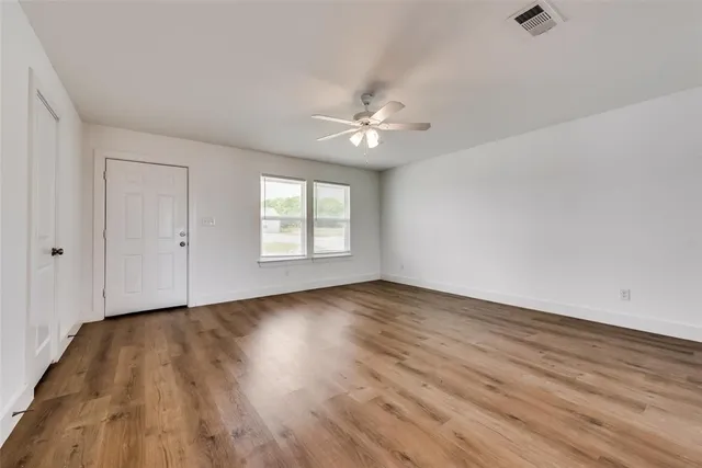 wooden floor in an empty room with a window