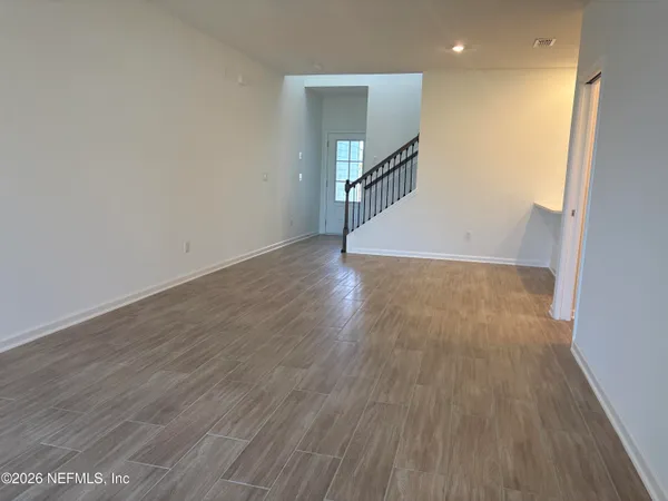 a kitchen with white cabinets and black appliances