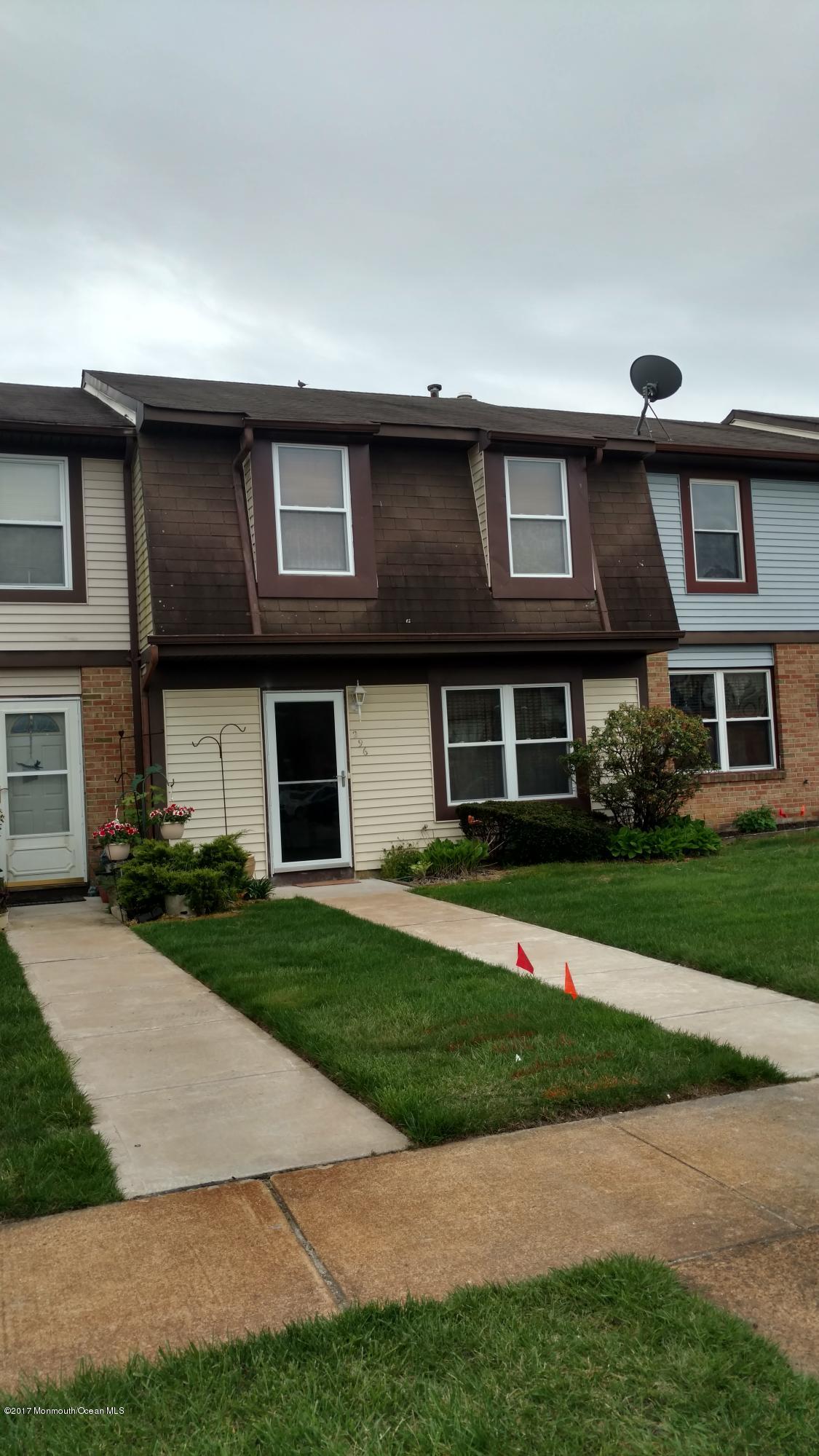 296 Greenwood Loop Road Brick, NJ 08724 - Photo 1 of 15 a front view of a house with a yard and garage
