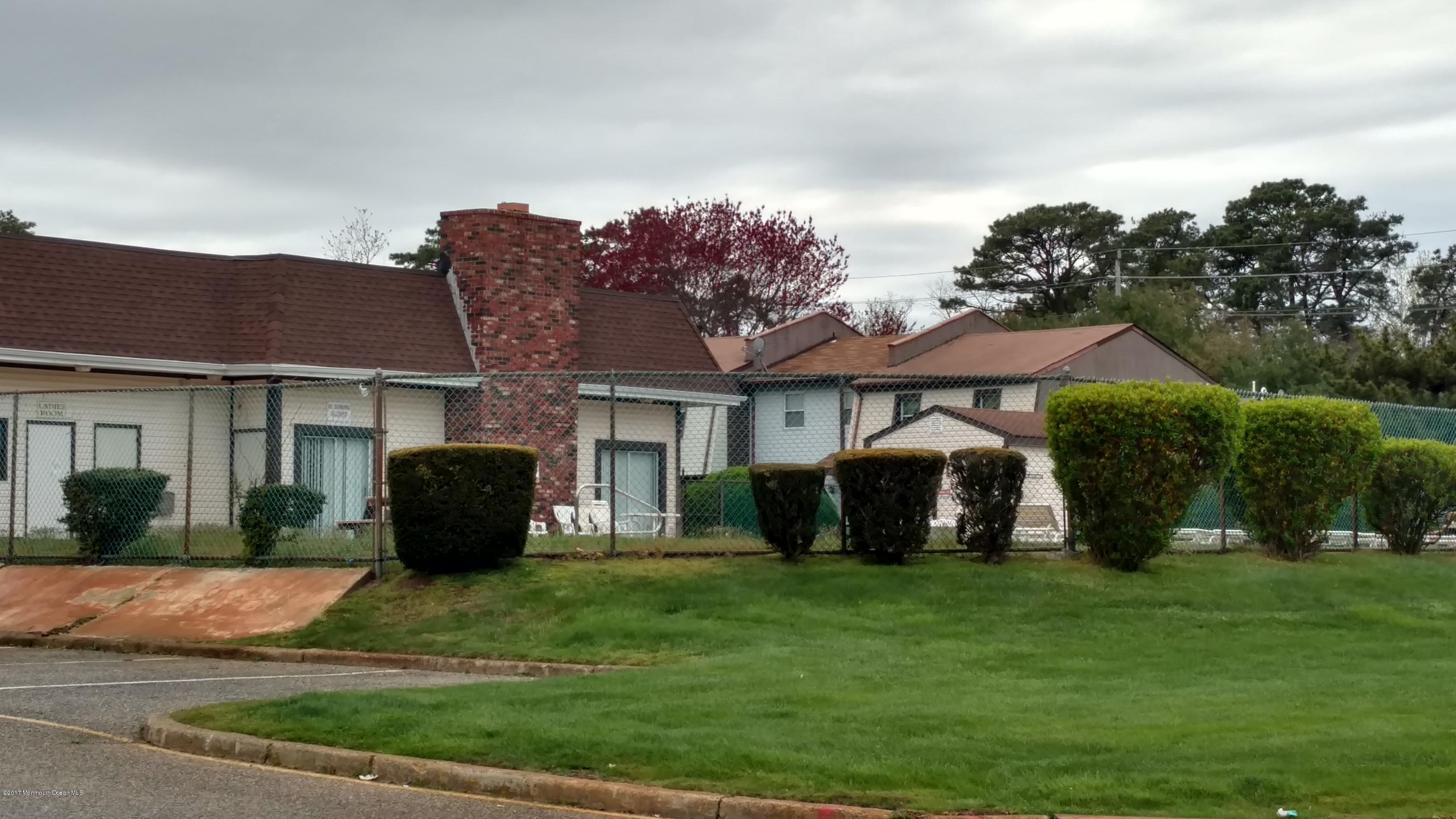 296 Greenwood Loop Road Brick, NJ 08724 - Photo 11 of 15 a front view of a house with a garden and yard
