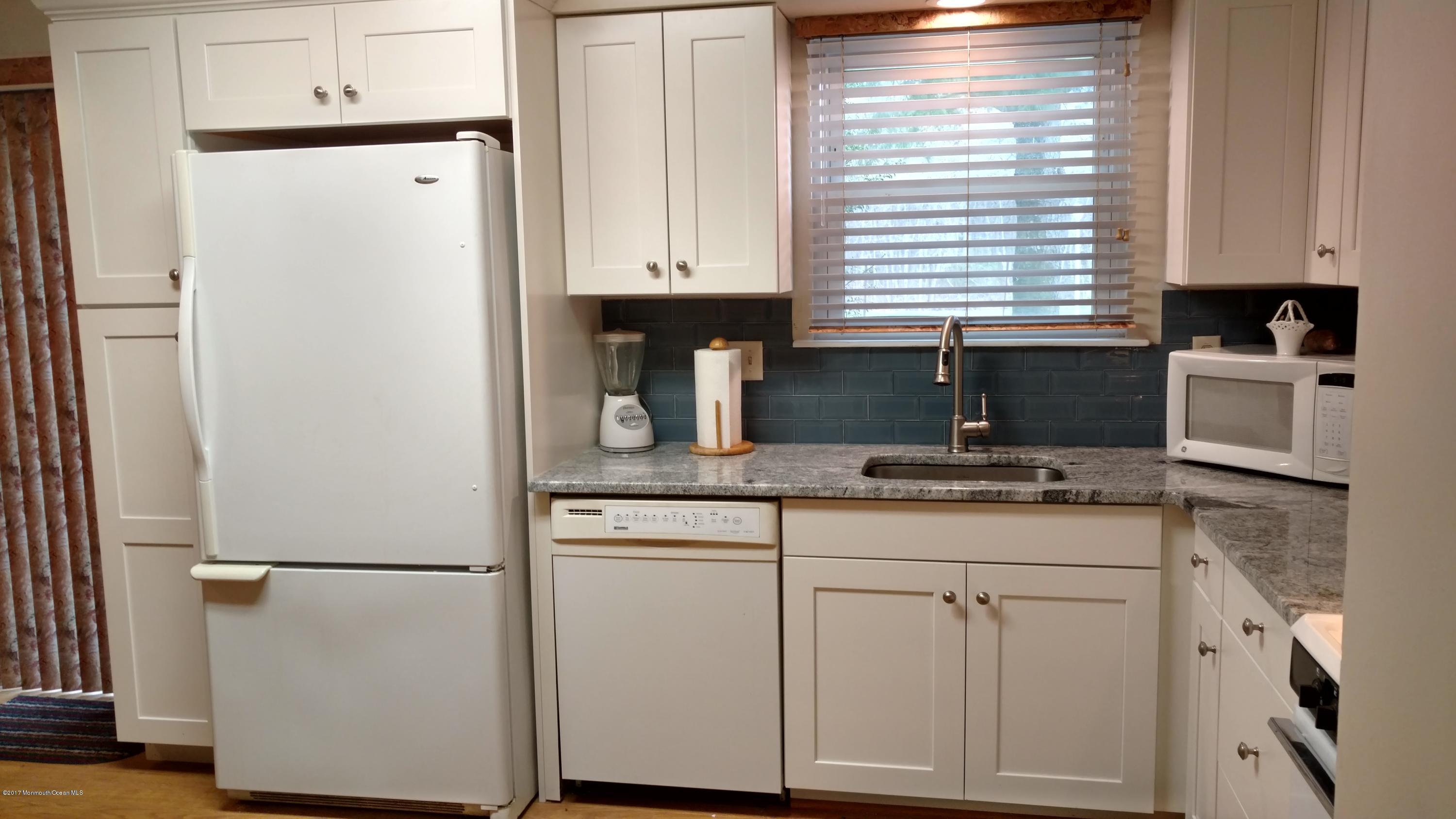 296 Greenwood Loop Road Brick, NJ 08724 - Photo 3 of 15 a kitchen with appliances a sink and cabinets