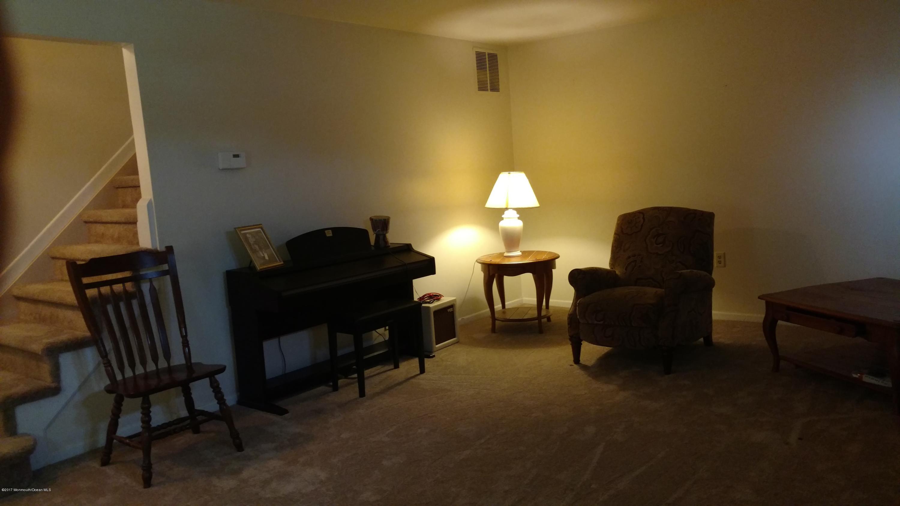 296 Greenwood Loop Road Brick, NJ 08724 - Photo 4 of 15 a living room with furniture and a lamp