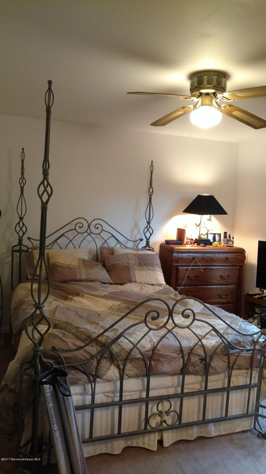 296 Greenwood Loop Road Brick, NJ 08724 - Photo 5 of 15 a bedroom with a bed and ceiling fan