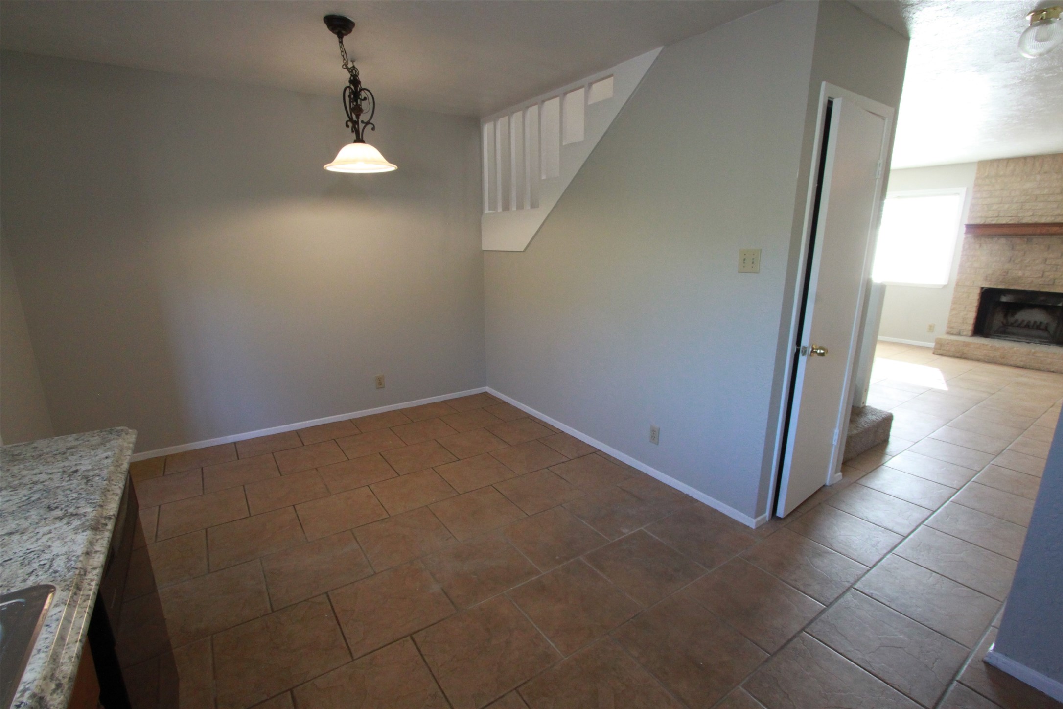 3904 Hudson Bend Road, Unit D Austin, TX 78734 - Photo 13 of 25 Unfurnished dining area with a fireplace and dark tile patterned floors