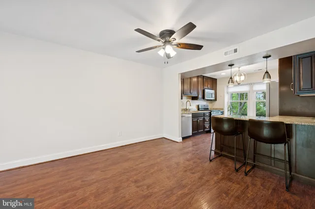 a workspace with wooden floor and a window
