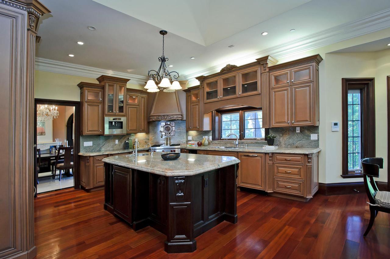 630 Pullman Road Hillsborough, CA 94010 - Photo 23 of 24 a kitchen with kitchen island granite countertop a sink cabinets and wooden floor