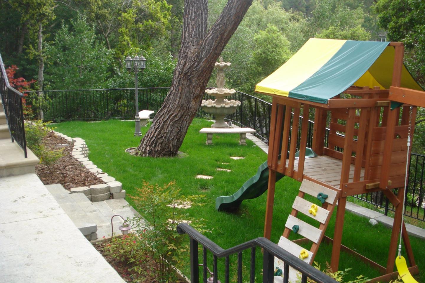 630 Pullman Road Hillsborough, CA 94010 - Photo 5 of 24 a backyard of a house with lots of green space