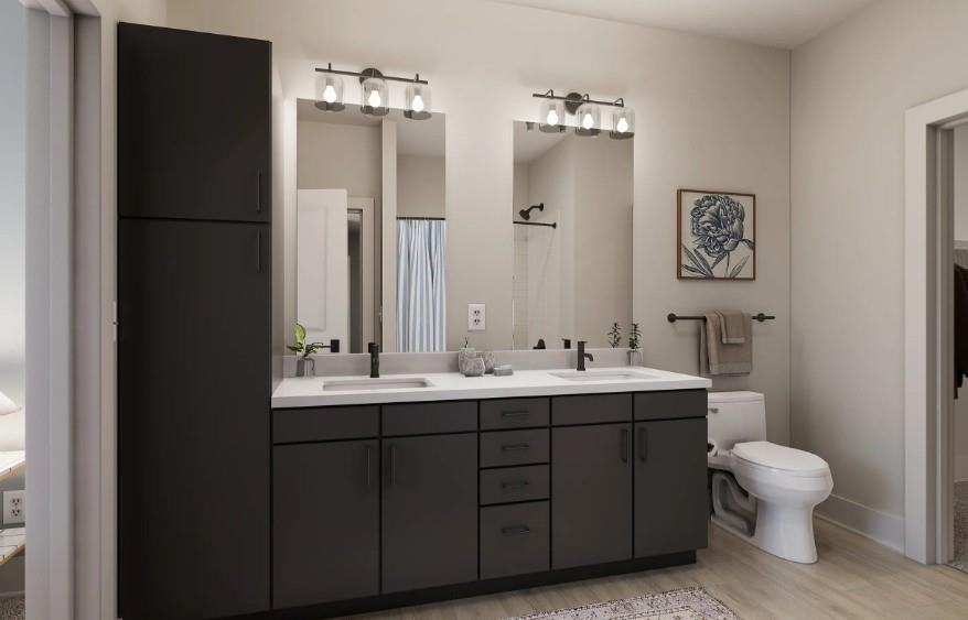 1400 Laurel Crossing Parkway Northeast, Unit 1105 Buford, GA 30519 - Photo 14 of 33 a bathroom with a toilet sink and mirror