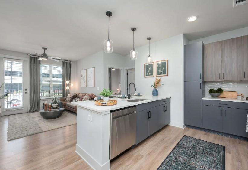 1400 Laurel Crossing Parkway Northeast, Unit 1105 Buford, GA 30519 - Photo 3 of 33 a kitchen with a sink stove and cabinets
