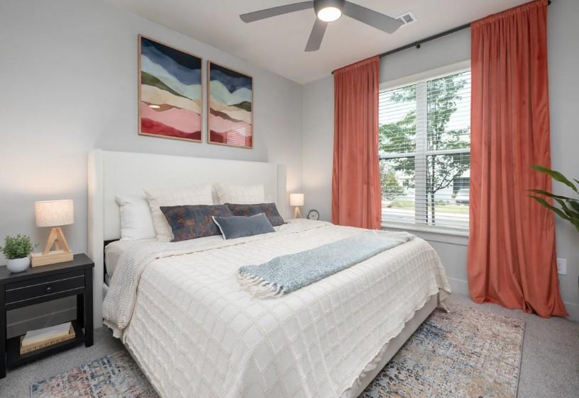 1400 Laurel Crossing Parkway Northeast, Unit 1105 Buford, GA 30519 - Photo 7 of 33 a bedroom with bed and large window