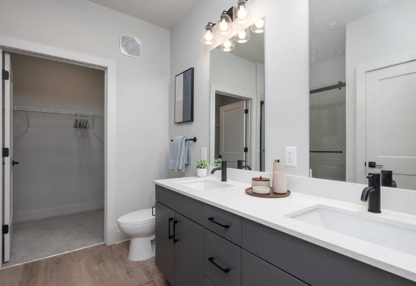 1400 Laurel Crossing Parkway Northeast, Unit 1105 Buford, GA 30519 - Photo 9 of 33 a bathroom with a sink a toilet and shower