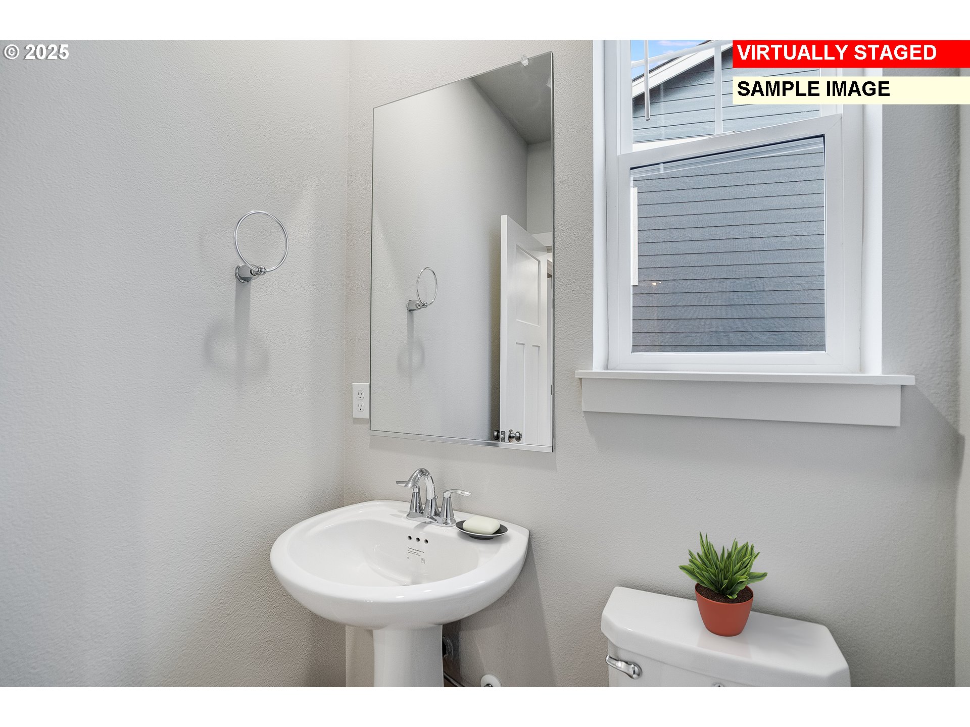 16921 Southwest Lorikeet Lane Beaverton, OR 97007 - Photo 9 of 23 a bathroom with a sink a mirror and a potted plant