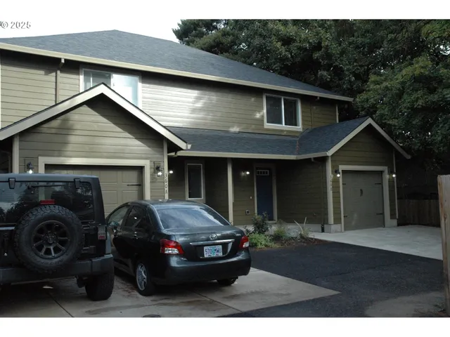a view of house and car parked in front of house