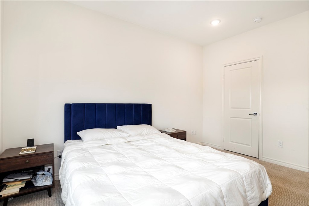 1380 Vigilant Carson, CA 90746 - Photo 21 of 43 a large bed sitting in a bedroom and a table