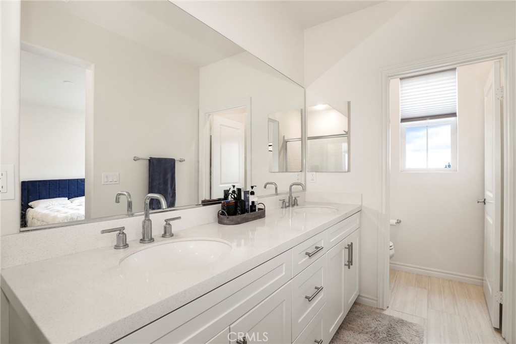1380 Vigilant Carson, CA 90746 - Photo 23 of 43 a bathroom with double vanity sink and mirror