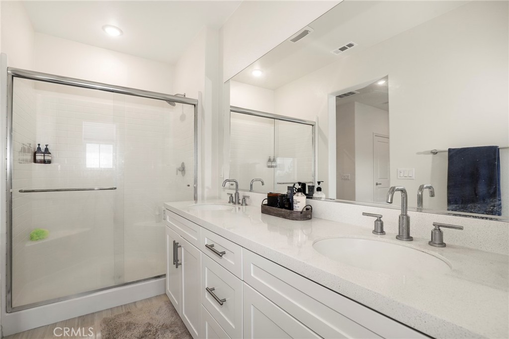 1380 Vigilant Carson, CA 90746 - Photo 24 of 43 a bathroom with double vanity sink and mirror