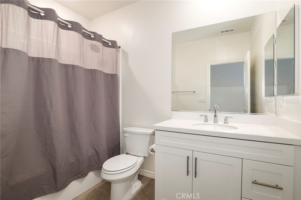 1380 Vigilant Carson, CA 90746 - Photo 27 of 43 a bathroom with a sink a toilet a mirror and shower curtain