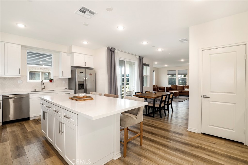 1380 Vigilant Carson, CA 90746 - Photo 4 of 43 a kitchen with a table chairs stove and cabinets