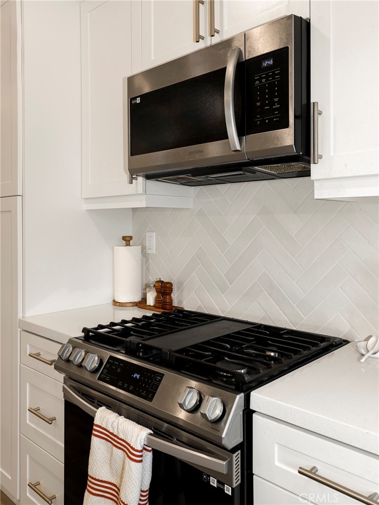 1380 Vigilant Carson, CA 90746 - Photo 5 of 43 a close view of a stove a microwave and cabinets