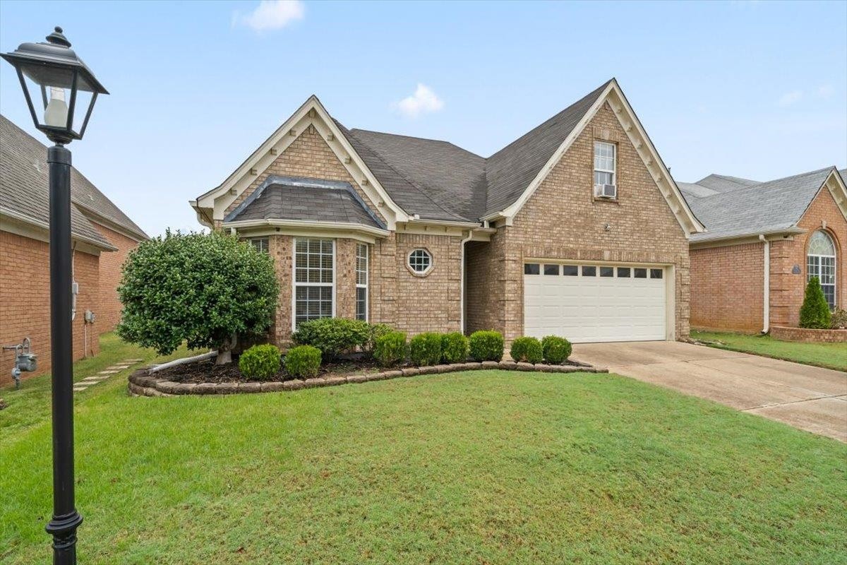 10470 Ashfarm Way Collierville, TN 38017 - Photo 1 of 15 a front view of a house with a yard
