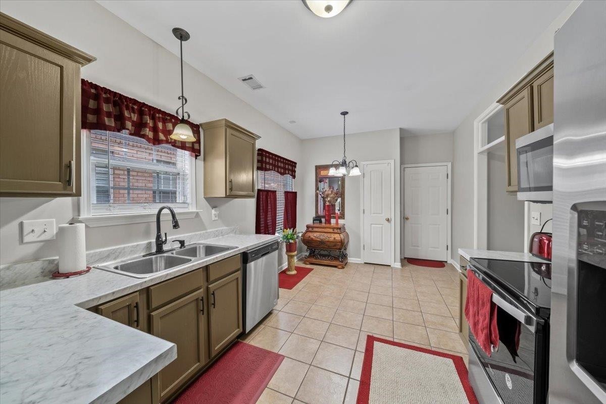 10470 Ashfarm Way Collierville, TN 38017 - Photo 6 of 15 a kitchen that has a lot of cabinets in it