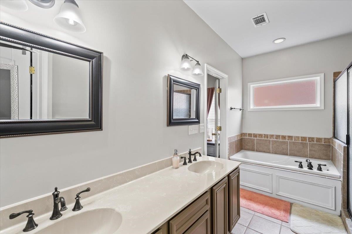 10470 Ashfarm Way Collierville, TN 38017 - Photo 10 of 15 a bathroom with a tub sink and mirror