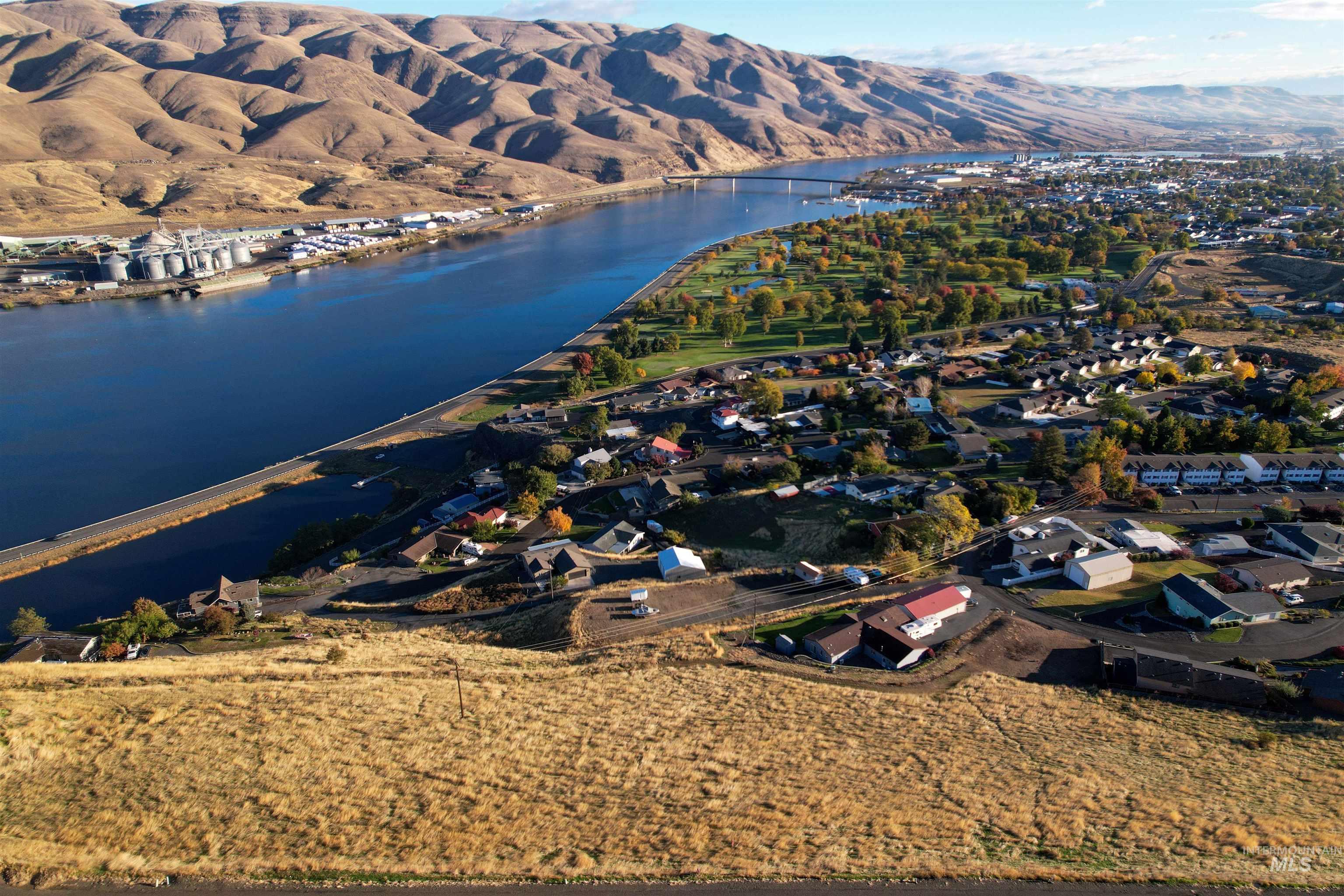 View of property location with nearby suburban area and a water and mountain view
