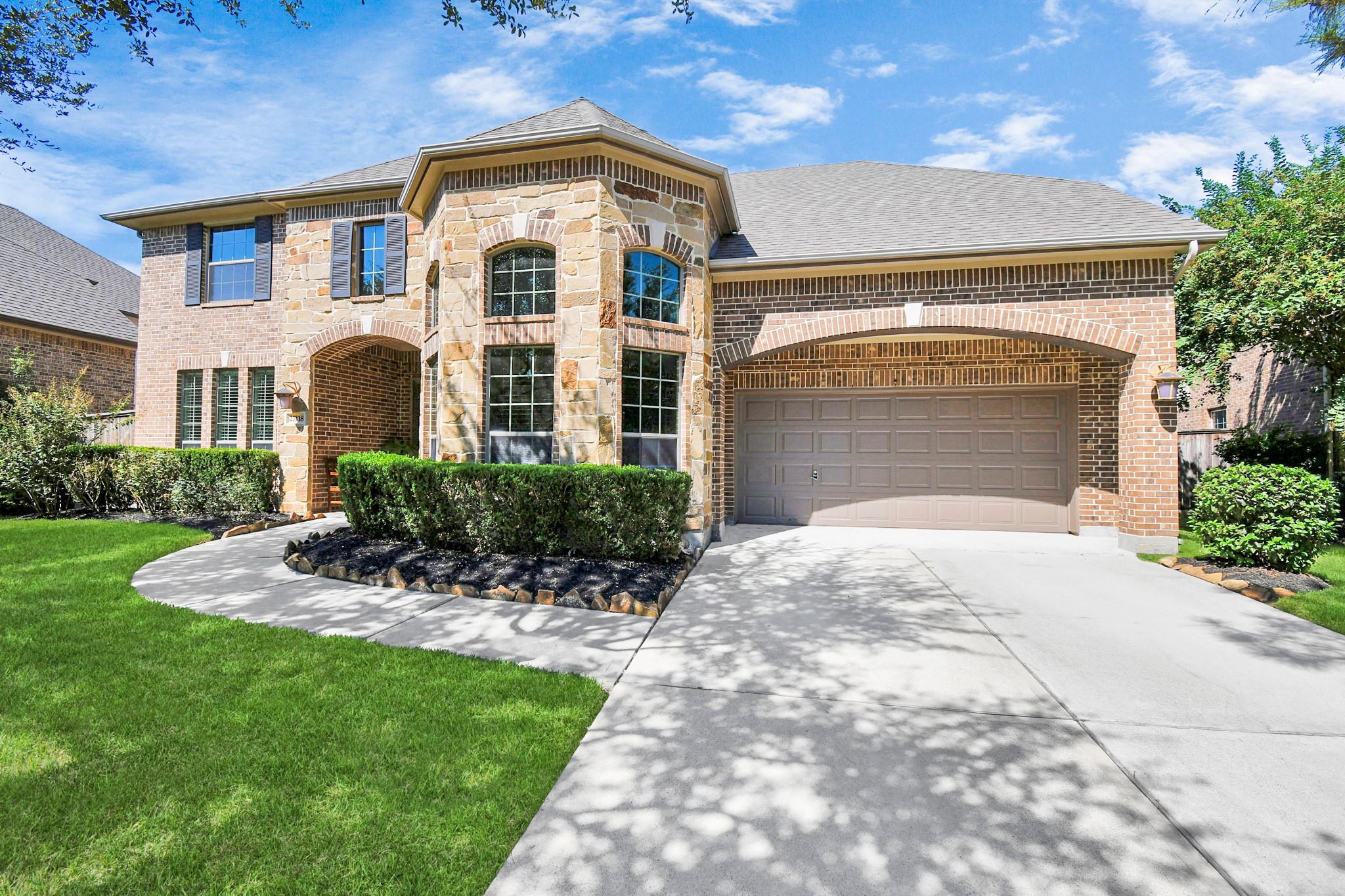 27118 Cardiff Rocks Drive Katy, TX 77494 - Photo 11 of 50 a front view of a house with a garden