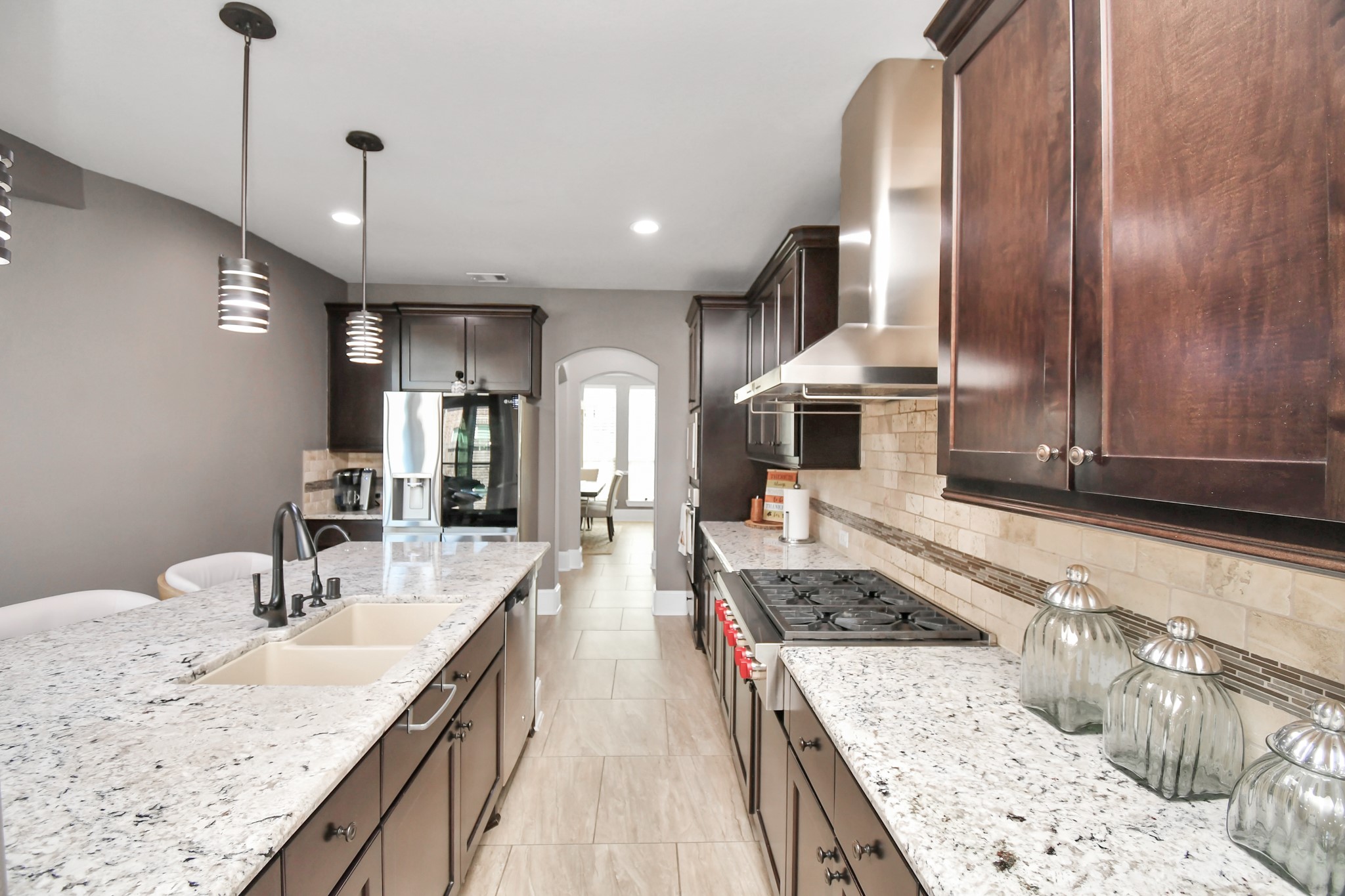 27118 Cardiff Rocks Drive Katy, TX 77494 - Photo 19 of 50 a kitchen with stainless steel appliances granite countertop a sink stove and refrigerator