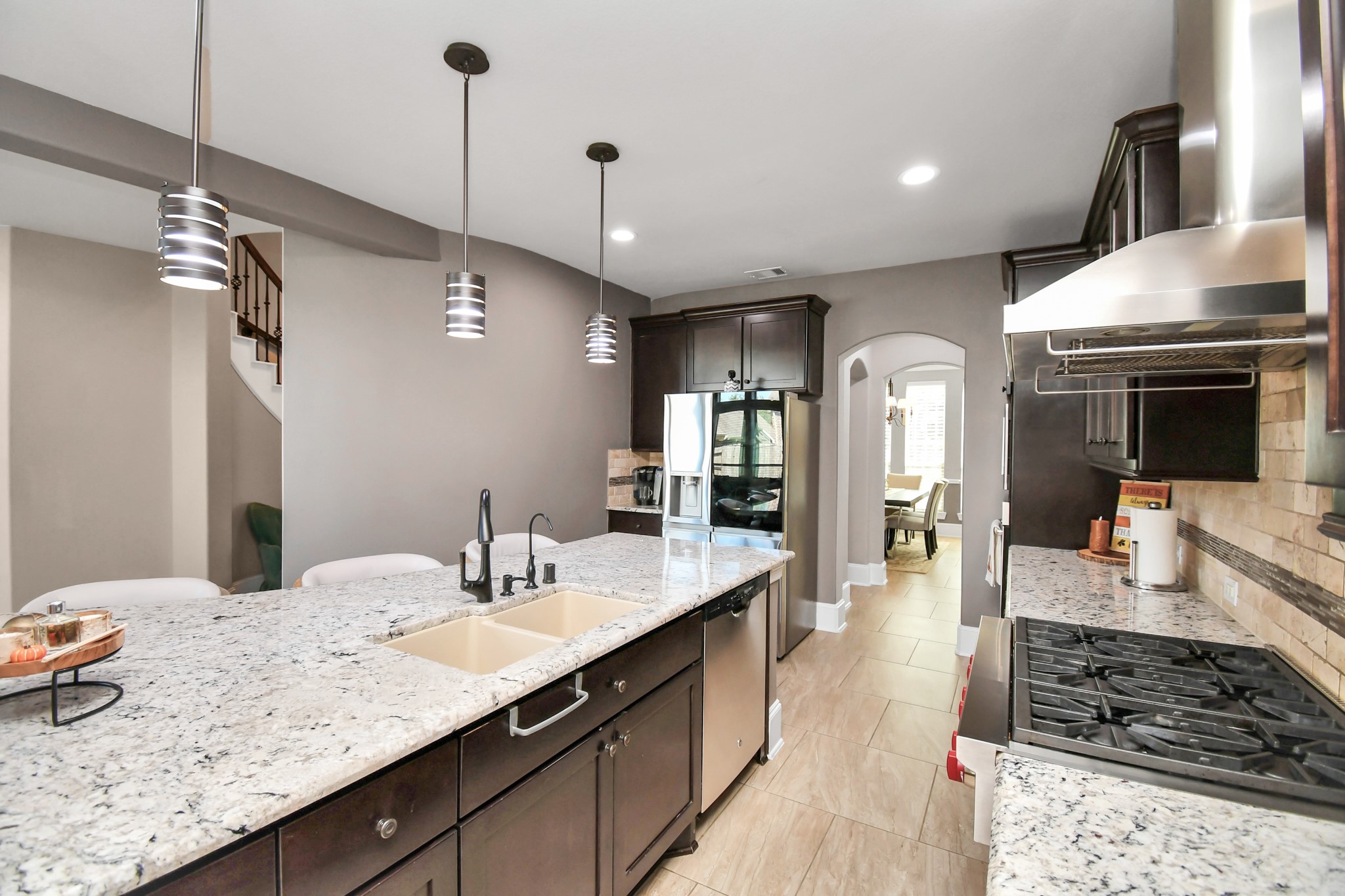 27118 Cardiff Rocks Drive Katy, TX 77494 - Photo 20 of 50 a large kitchen with kitchen island a counter space a sink stainless steel appliances and cabinets