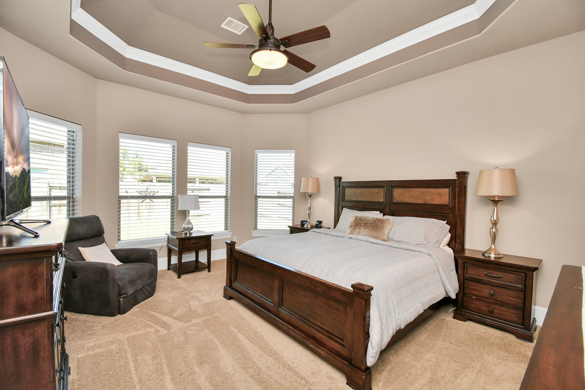 27118 Cardiff Rocks Drive Katy, TX 77494 - Photo 25 of 50 a bedroom with a bed couch and a large window