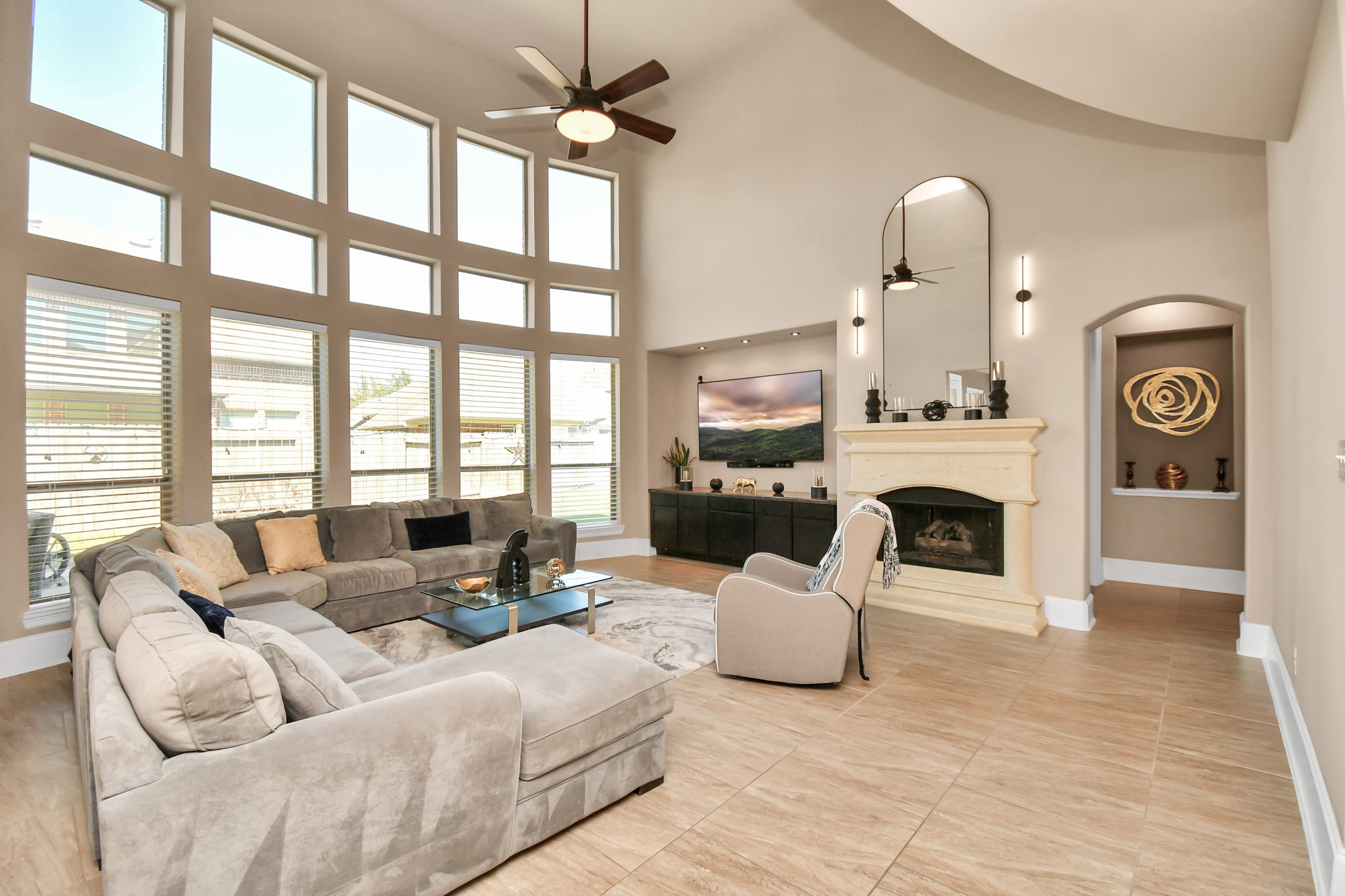 27118 Cardiff Rocks Drive Katy, TX 77494 - Photo 3 of 50 a living room with furniture a fireplace and a floor to ceiling window