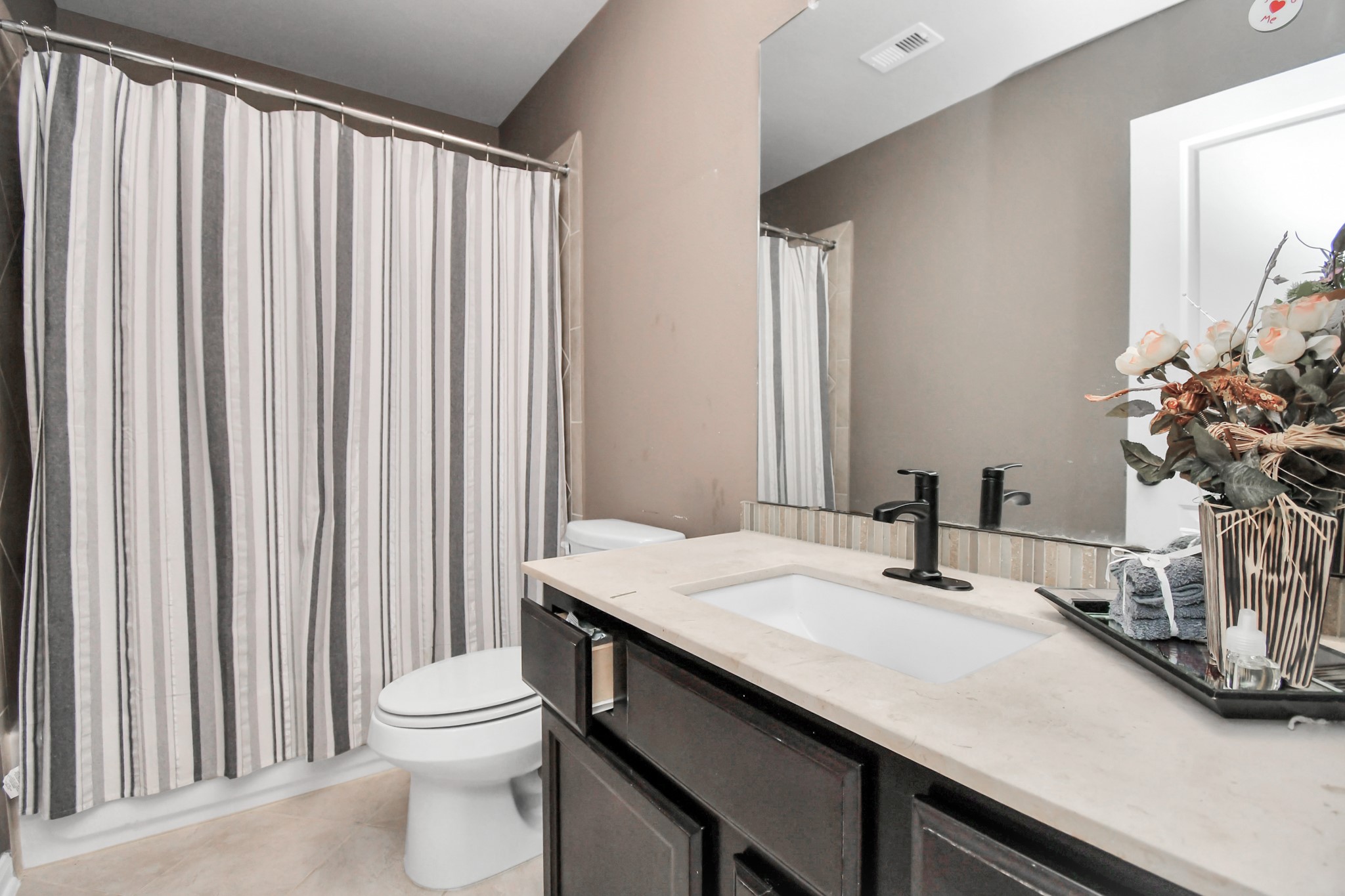 27118 Cardiff Rocks Drive Katy, TX 77494 - Photo 36 of 50 a bathroom with a granite countertop sink and a mirror