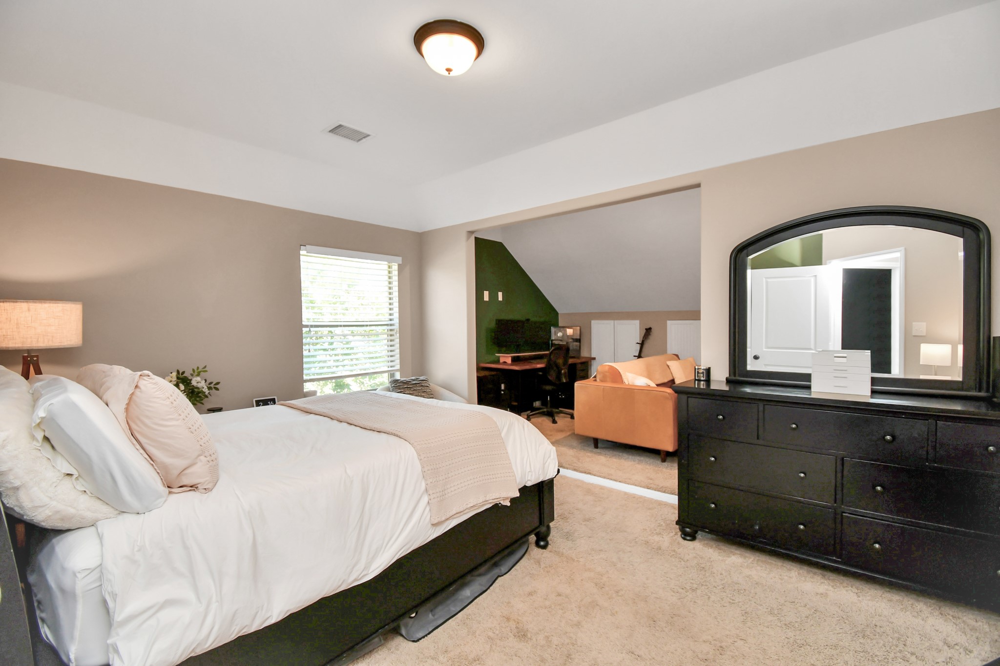 27118 Cardiff Rocks Drive Katy, TX 77494 - Photo 40 of 50 a bedroom with a bed and a large mirror on dresser next to a window