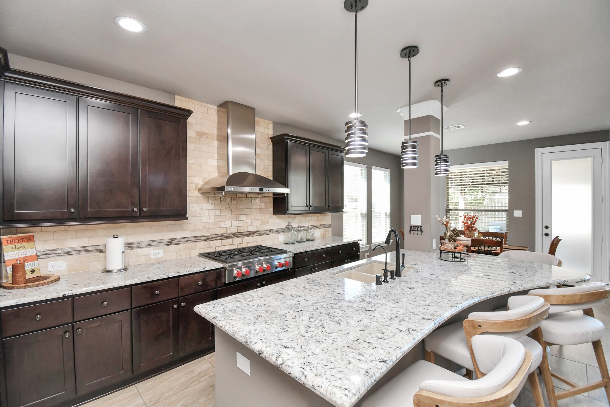27118 Cardiff Rocks Drive Katy, TX 77494 - Photo 4 of 50 a kitchen with granite countertop a sink and a wooden floor