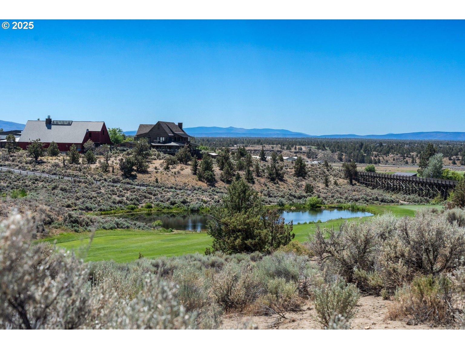 0 Southwest Brasada Rnch Road, Unit 649 Powell Butte, OR 97753 - Photo 8 of 32 a view of a field with a building in background