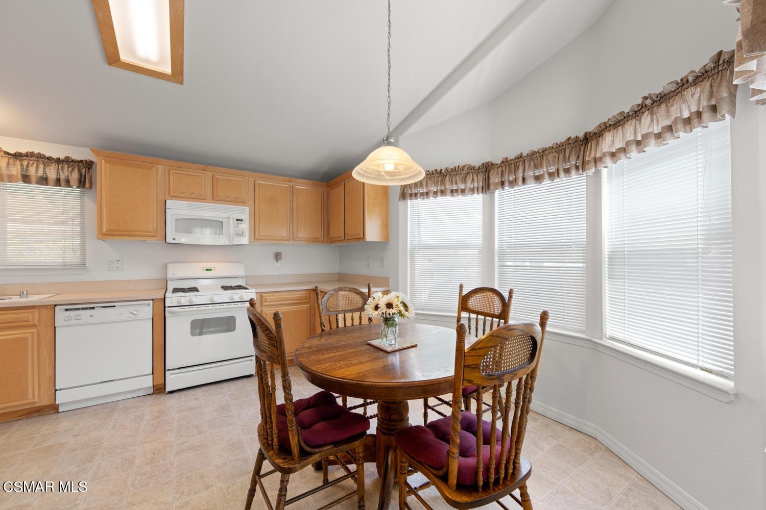 195 Tierra Rejada Road, Unit 155 Simi Valley, CA 93065 - Photo 14 of 33 a kitchen that has a table and chairs in it