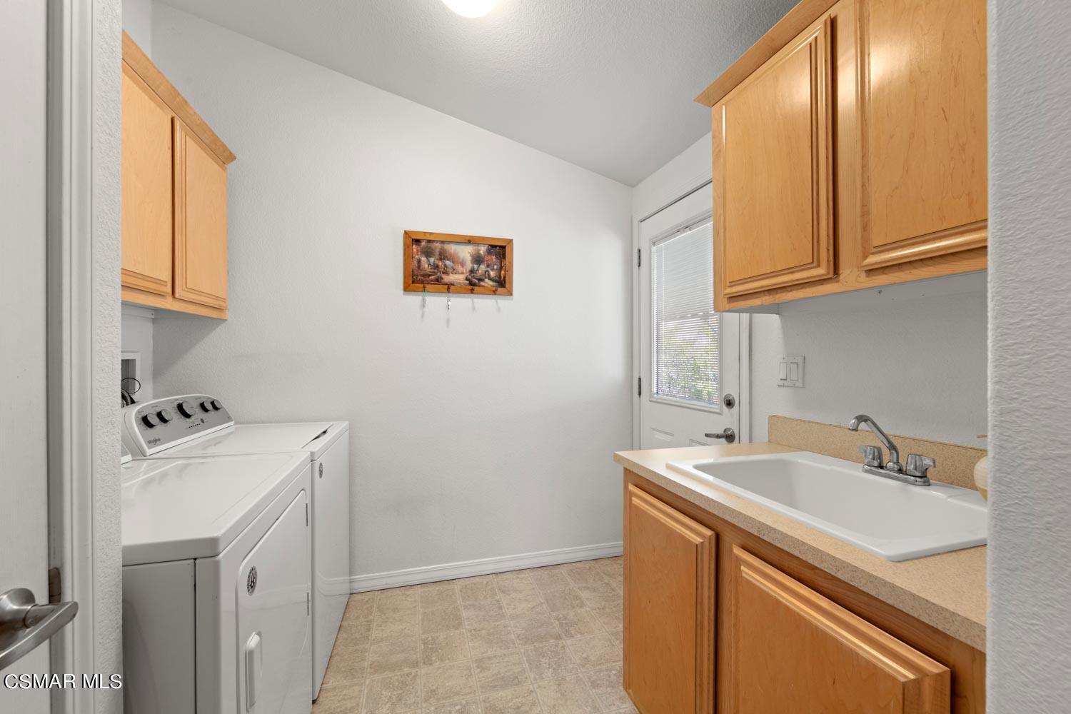 195 Tierra Rejada Road, Unit 155 Simi Valley, CA 93065 - Photo 18 of 33 a utility room with a sink a washer and dryer