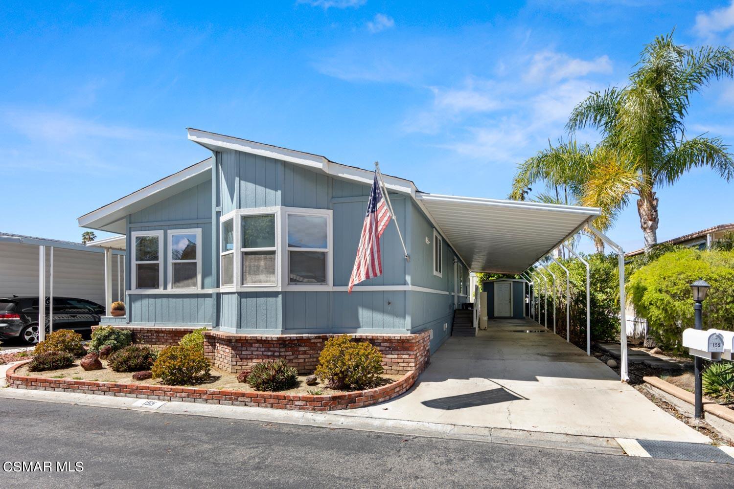 195 Tierra Rejada Road, Unit 155 Simi Valley, CA 93065 - Photo 2 of 33 a front view of a house with a yard