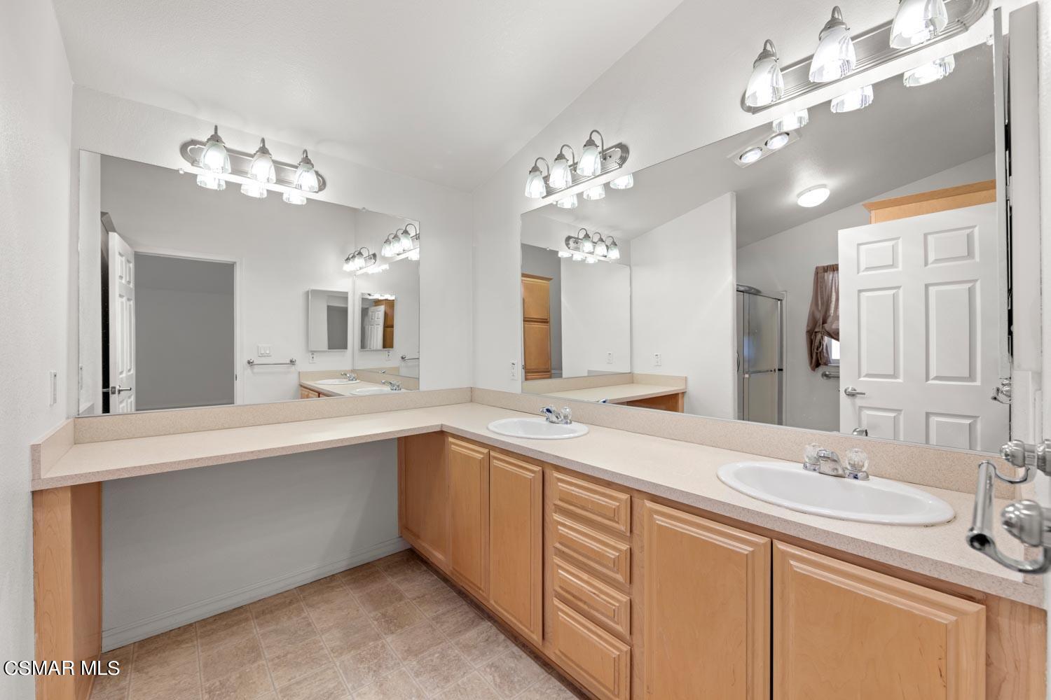 195 Tierra Rejada Road, Unit 155 Simi Valley, CA 93065 - Photo 25 of 33 a view of a double sink and chandelier
