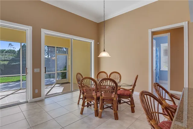 a view of a dining room and hall with furniture