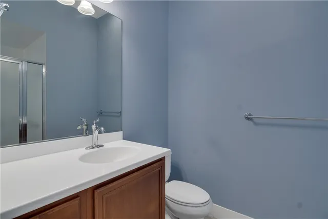 a bathroom with a sink a toilet and mirror