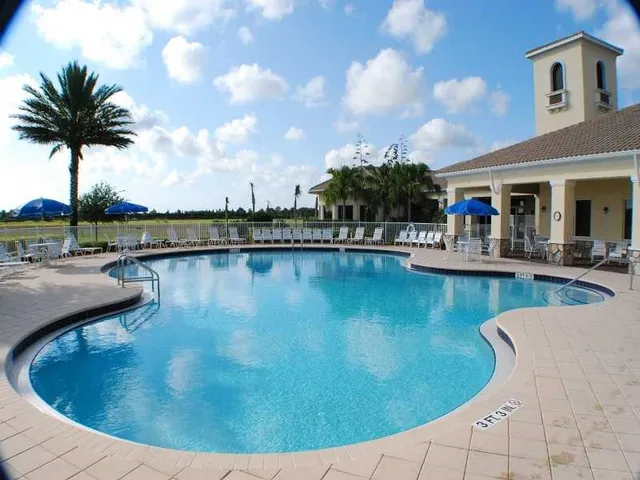 a view of a swimming pool with outdoor seating and plants