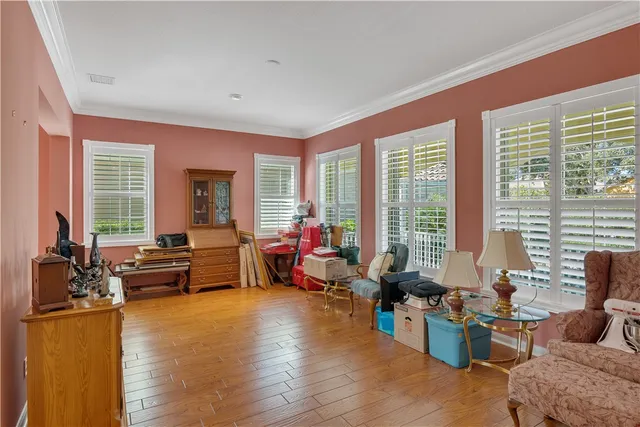 a living room with furniture and floor to ceiling windows