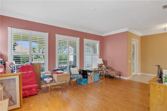 a view of a livingroom with workspace and a window
